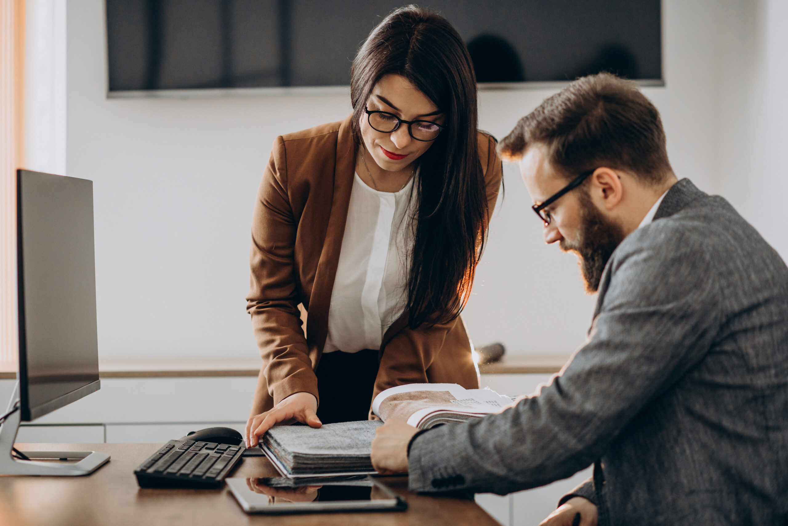 Two business partners working together in office on computer